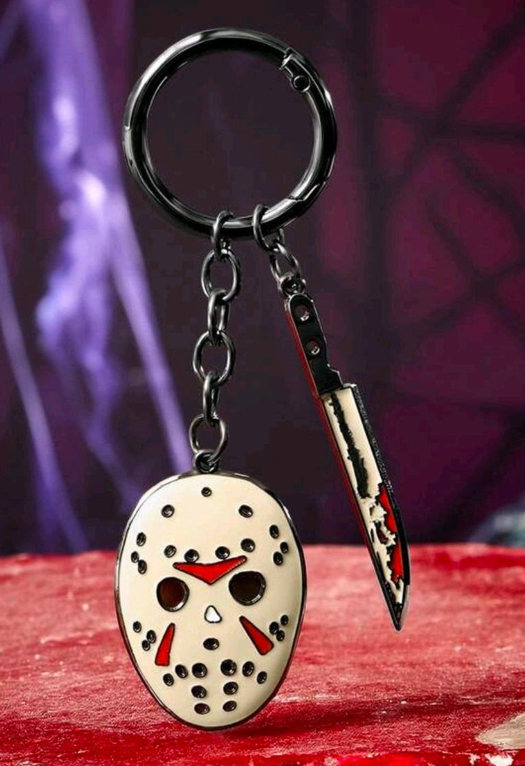 Enamel keychain with round hockey mask charm and red-and-black dagger charm on metal rings