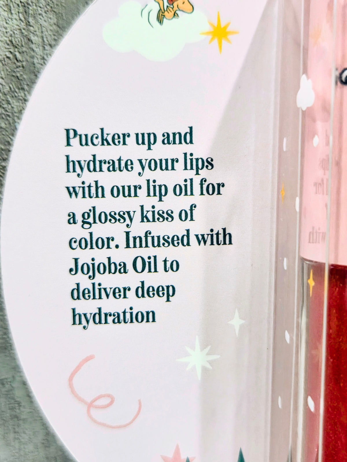 Tinted lip oil box panel with “Jojoba Oil” and “Pucker up” hydration message