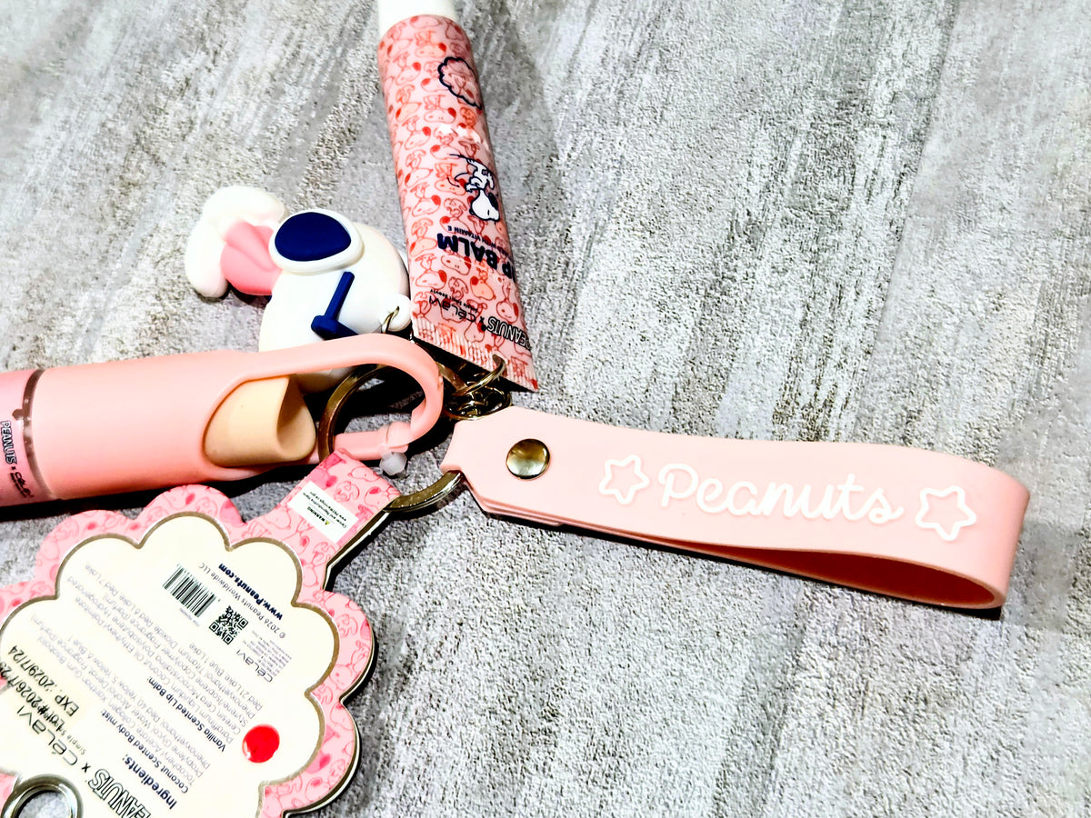 Peanuts keychain strap with Snoopy-themed label and attached bottle