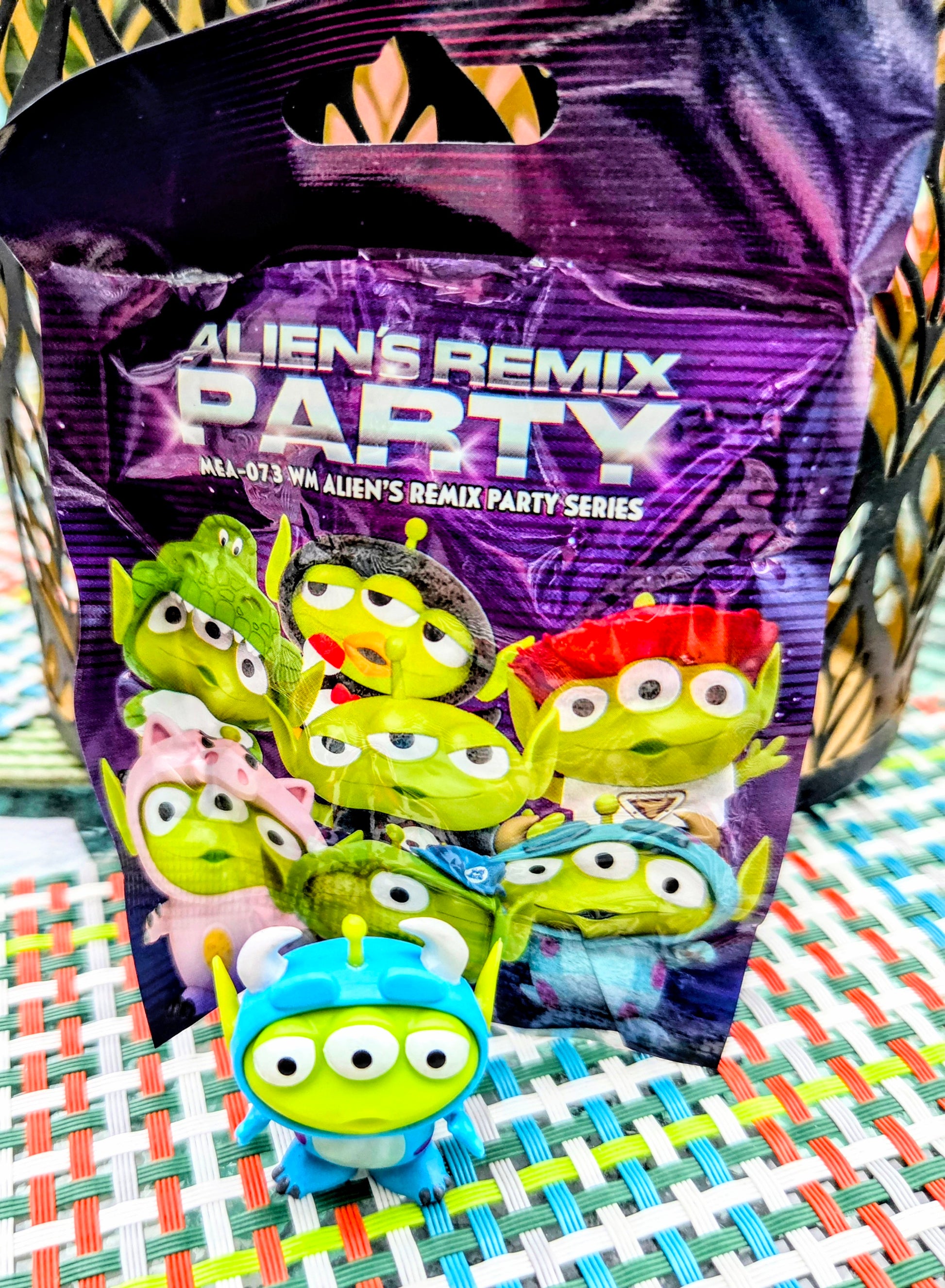 Alien themed blind box-style package with alien character artwork and mini figure