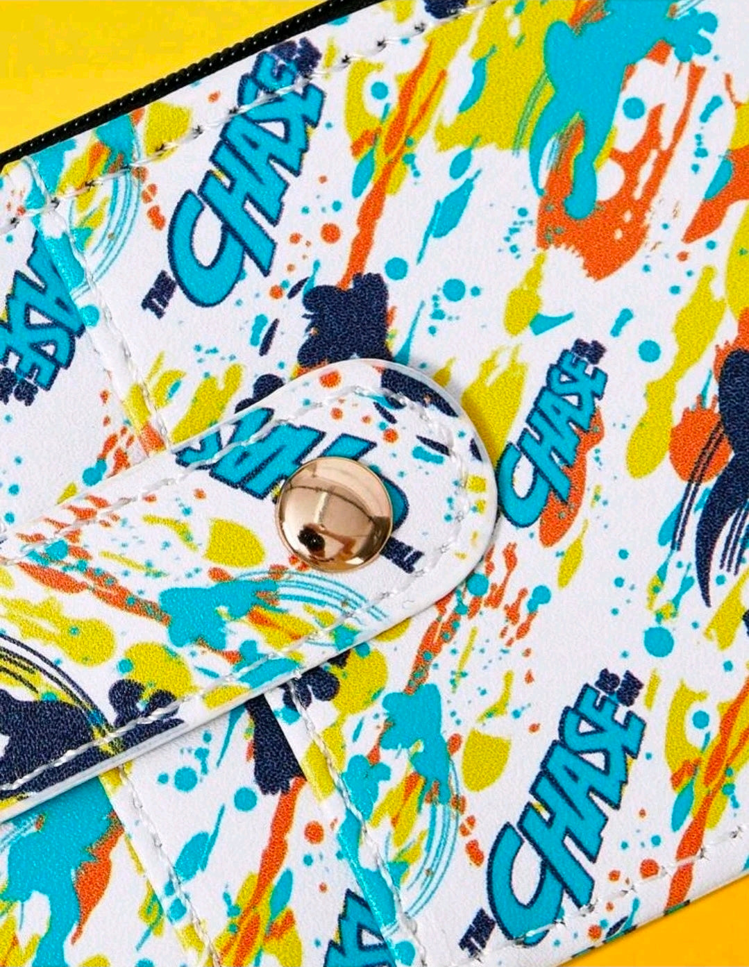 Paint-splash zipper wallet close-up with round metal keyring snap button detail