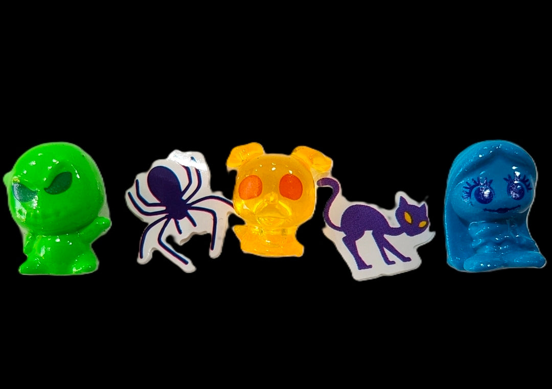 Assorted mini Squish'Alots character pieces on black background, five figures