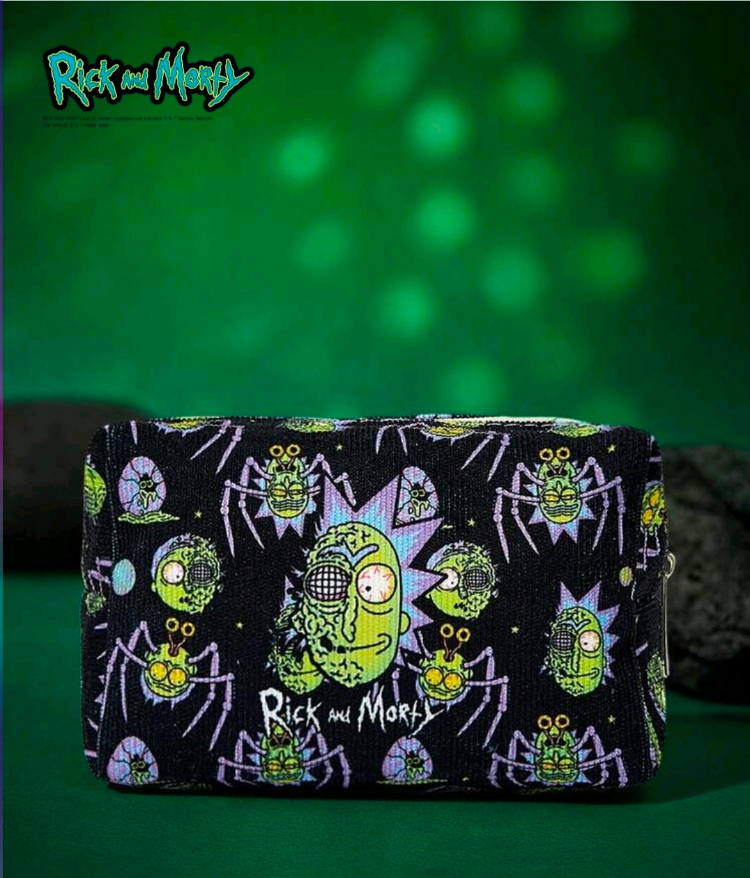 Black rectangular makeup bag with zipper, repeating sci-fi character pattern all over.