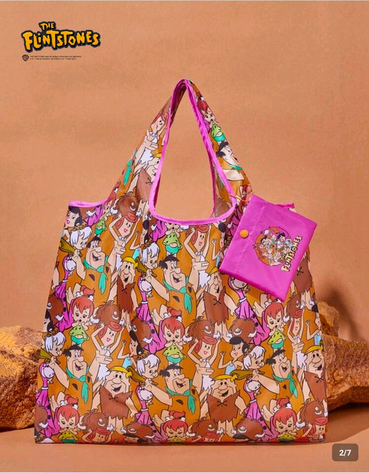 Foldable reusable shopping tote bag with colorful cartoon character print and pink side pocket