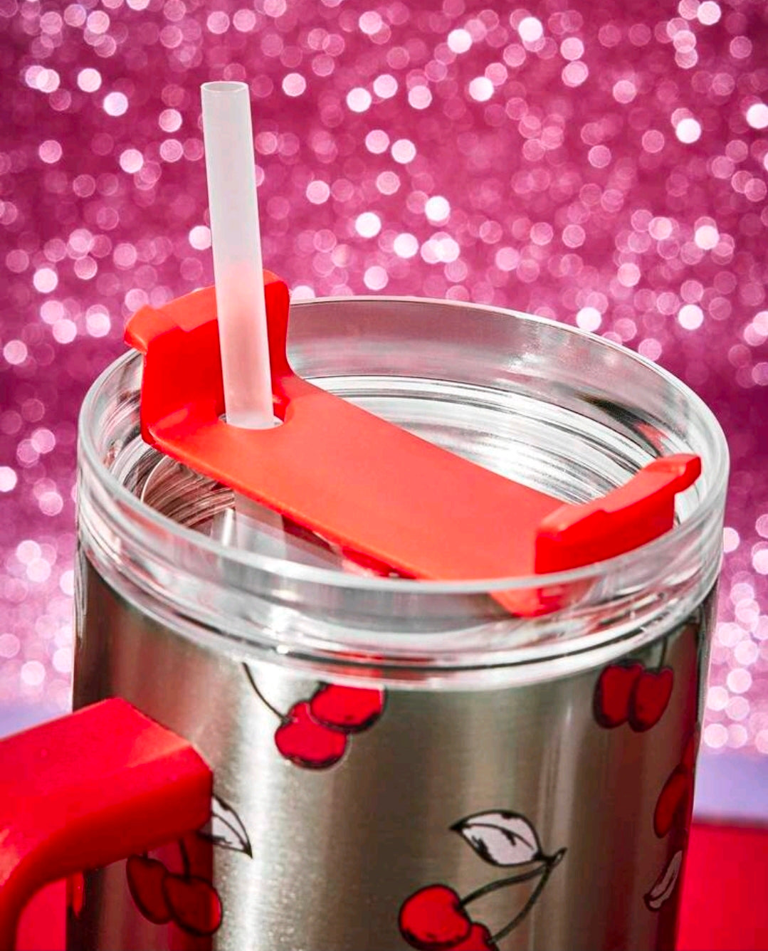 Stainless steel tumbler with red lid straw holder and red heart/cherry print.