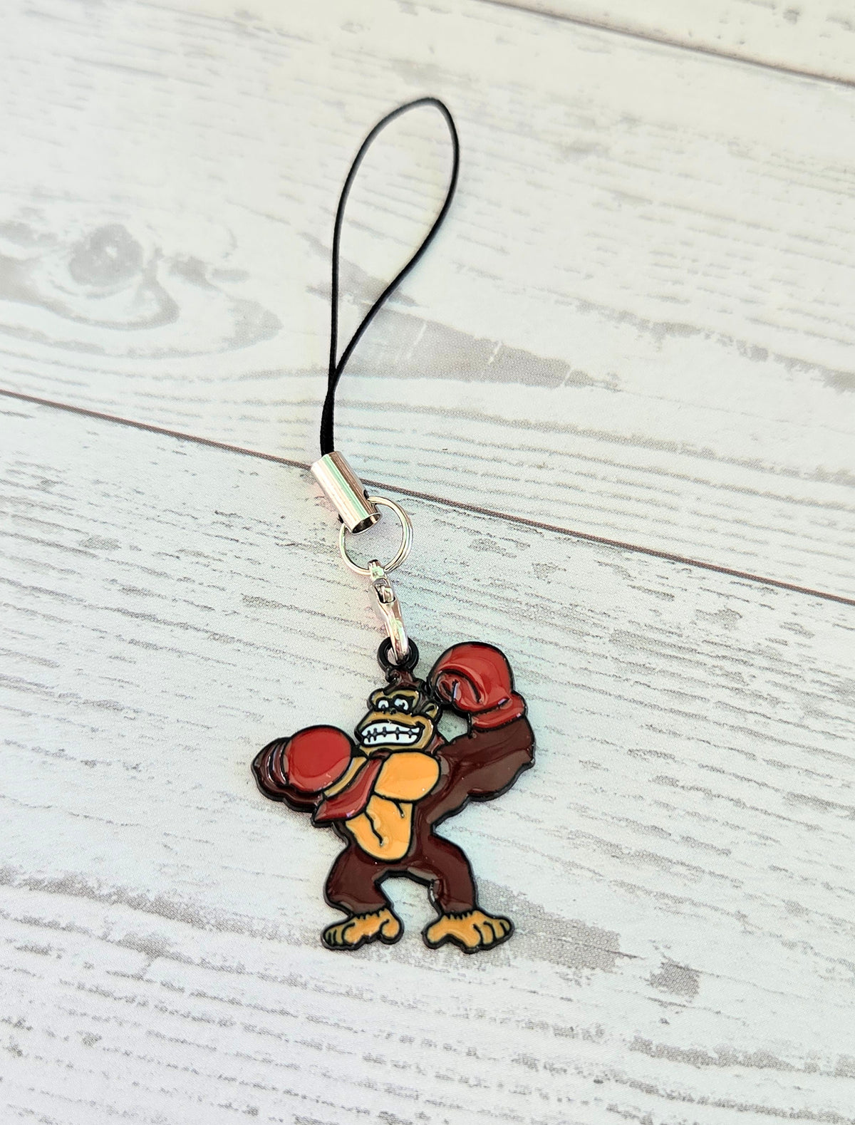 Donkey Kong enamel charm with black wrist strap and metal clasp