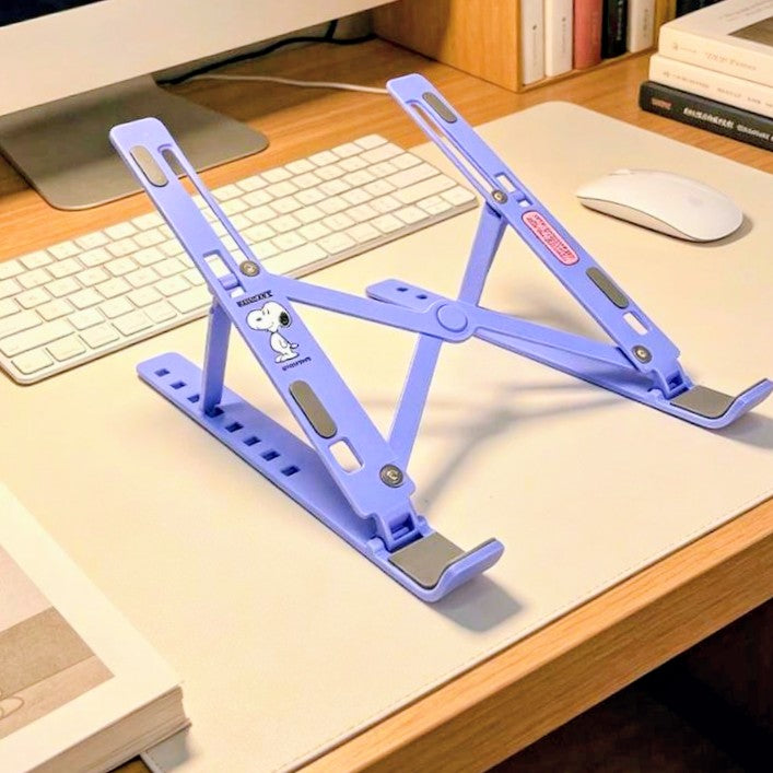 Purple adjustable foldable laptop stand with Snoopy graphics on desk