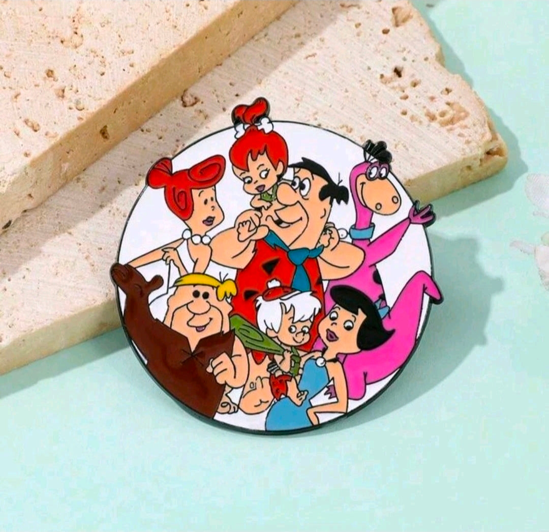 Round enamel pin brooch featuring The Flintstones family cartoon scene with dark border