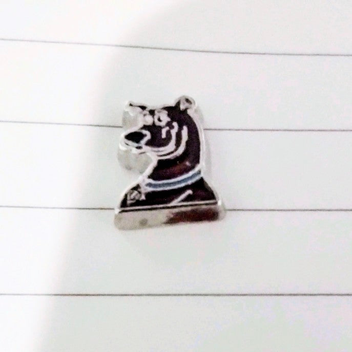Character floating charm: black dog figure with white face on round silver base