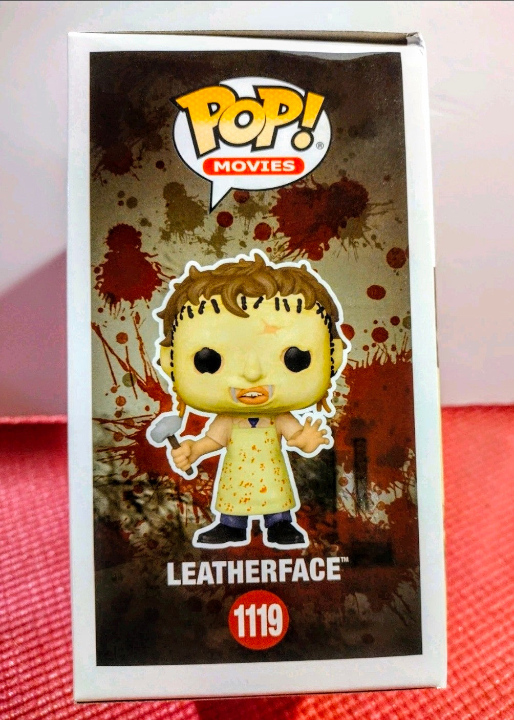 Vinyl figure in retail box with Leatherface character and red 1119 badge