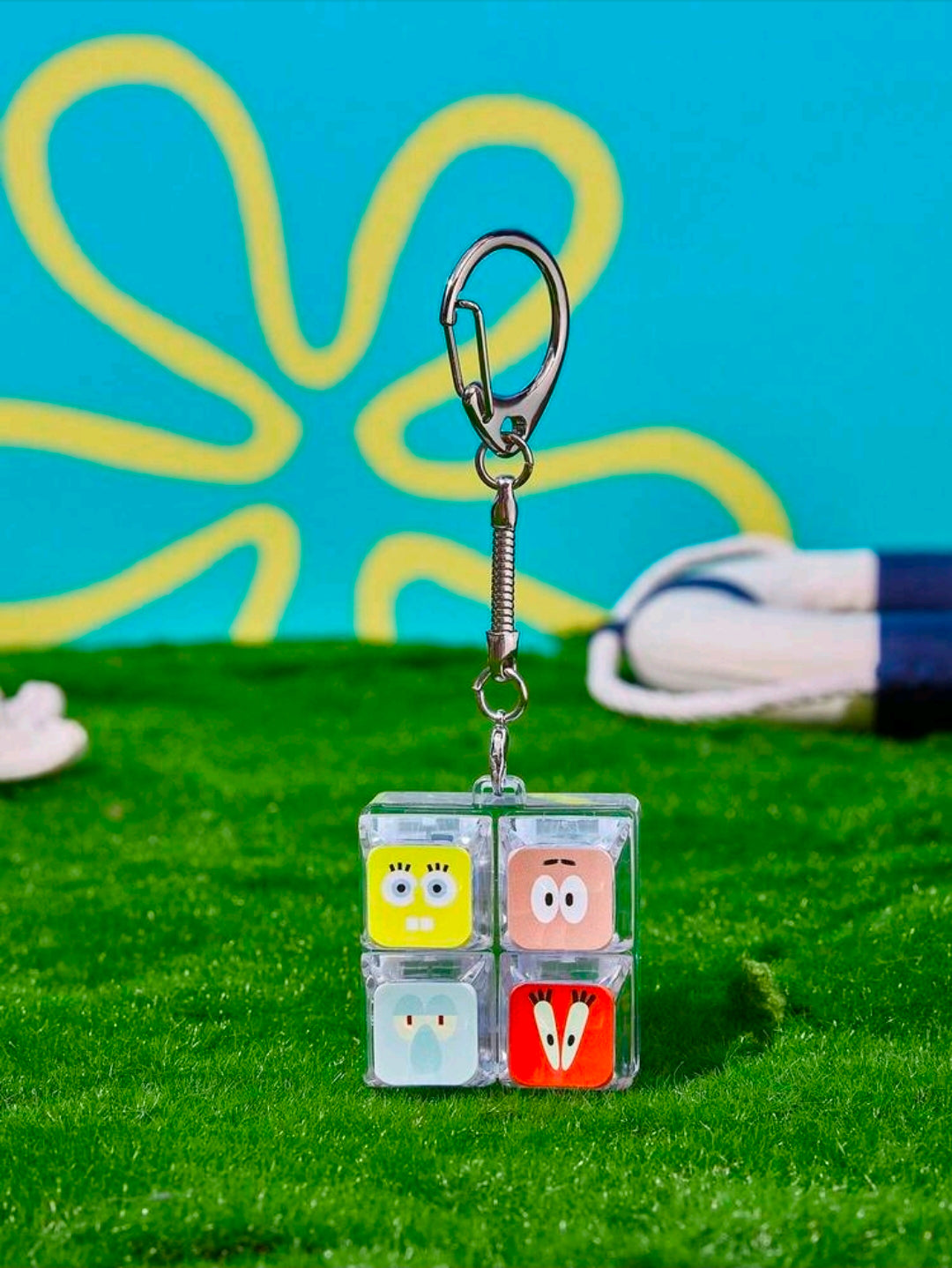 Clear 2x2 SpongeBob fidget keychain charm front view with four character tiles and keyring