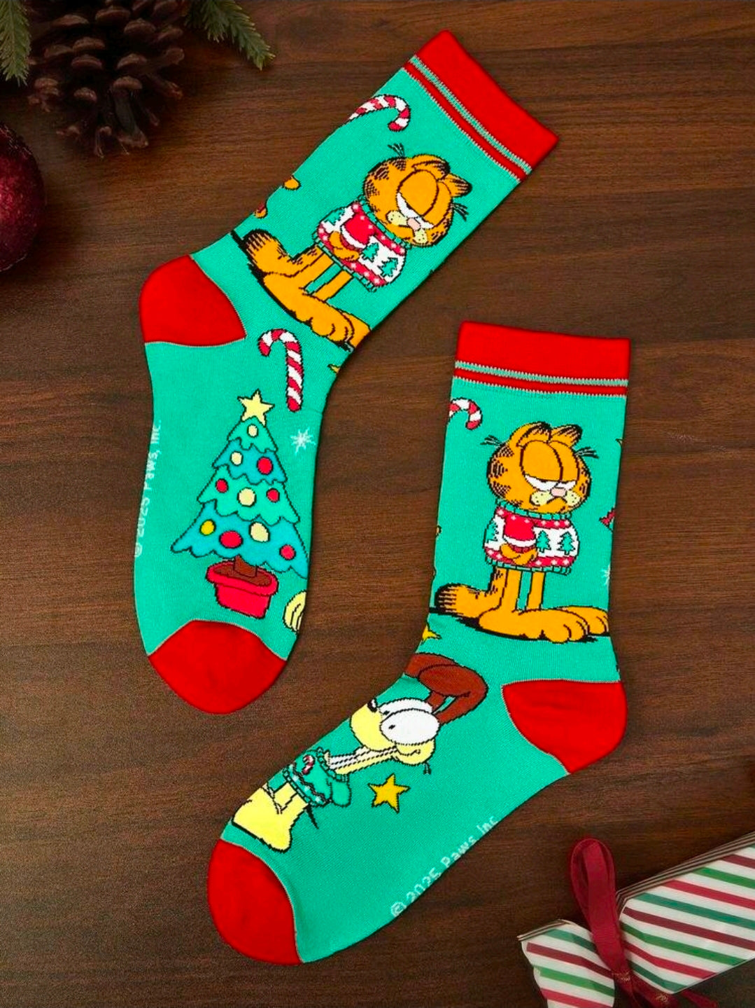 Teal crew socks with red toes and Garfield wearing a holiday sweater design