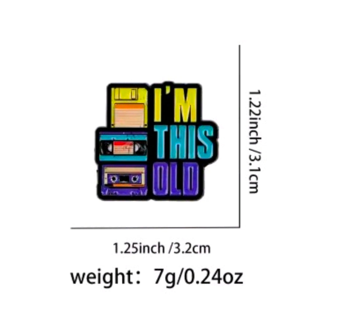 Enamel pin with cassette stack and text 'I'm This Old' on white card