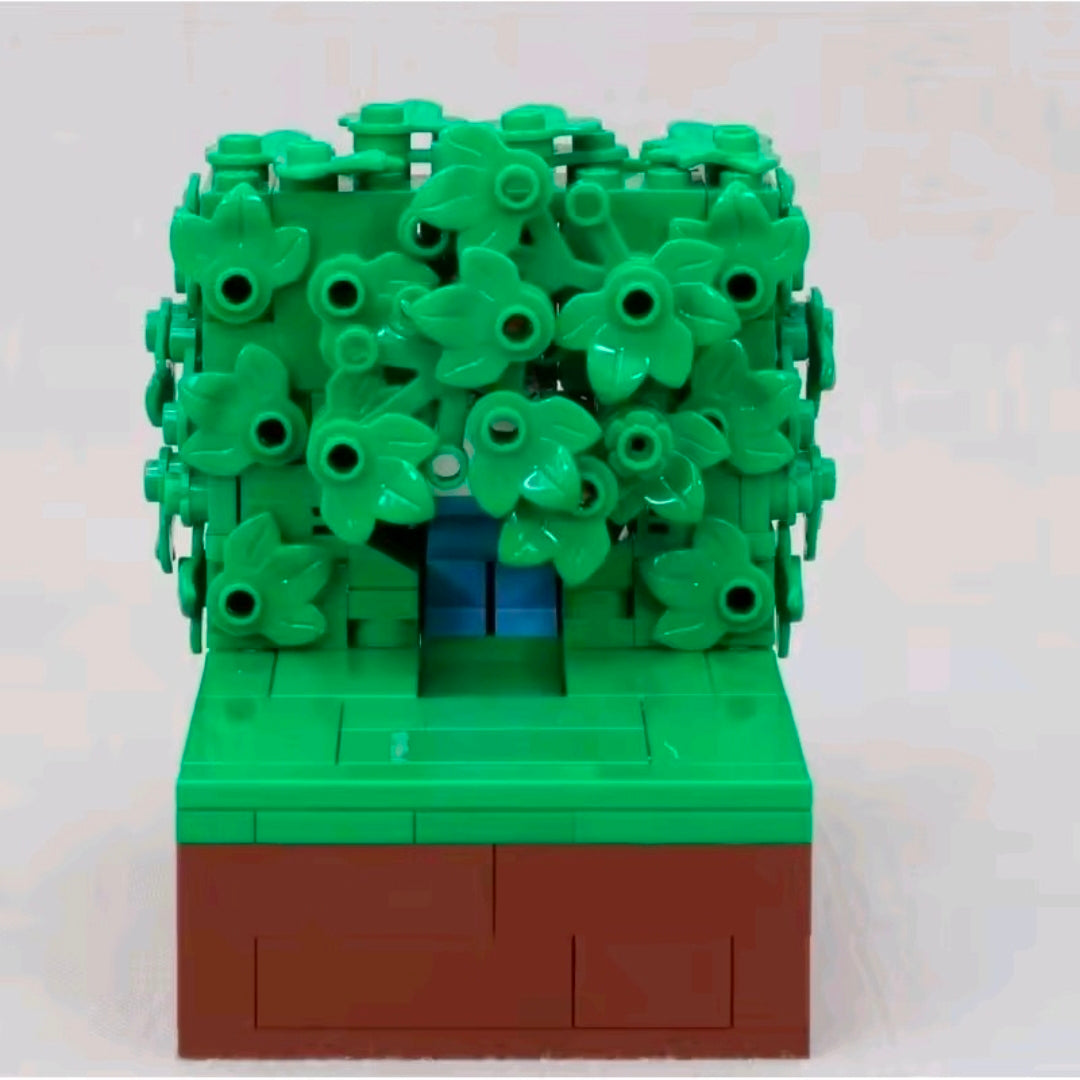 Front view brick build with dense dark green foliage and brown base platform.