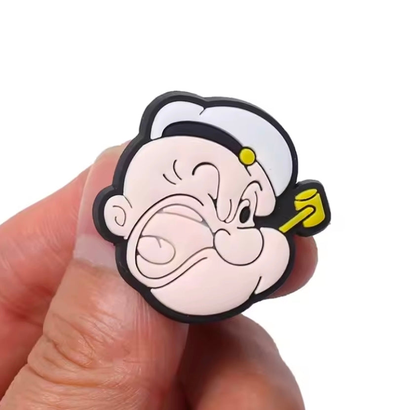Popeye PVC shoe charm head close-up with black hair and yellow earring
