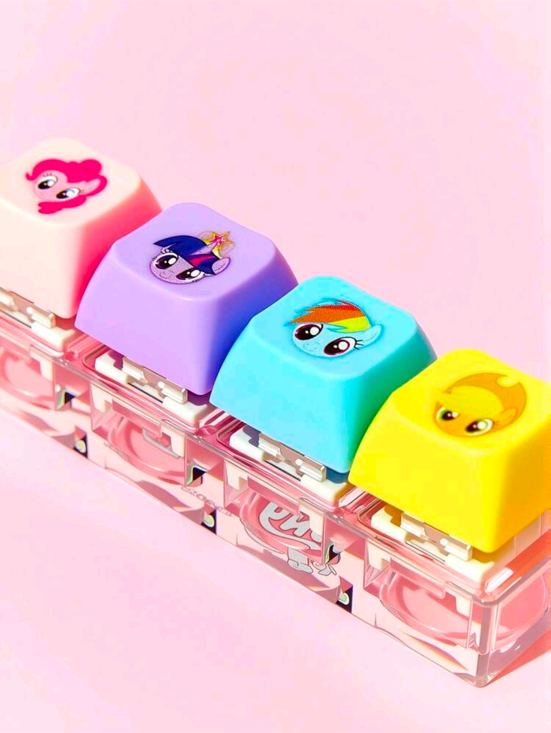 Keyboard clicker fidget keychain showing four colorful keys on clear base