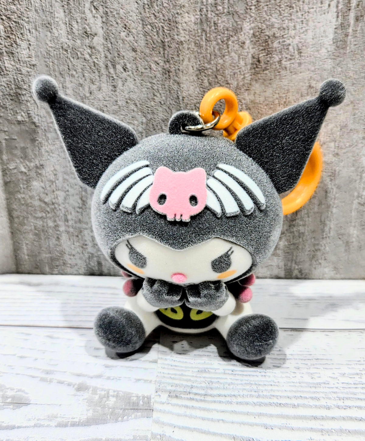 Gray flocked plush bag clip with orange loop handle, winged cat costume, and pink pig hood