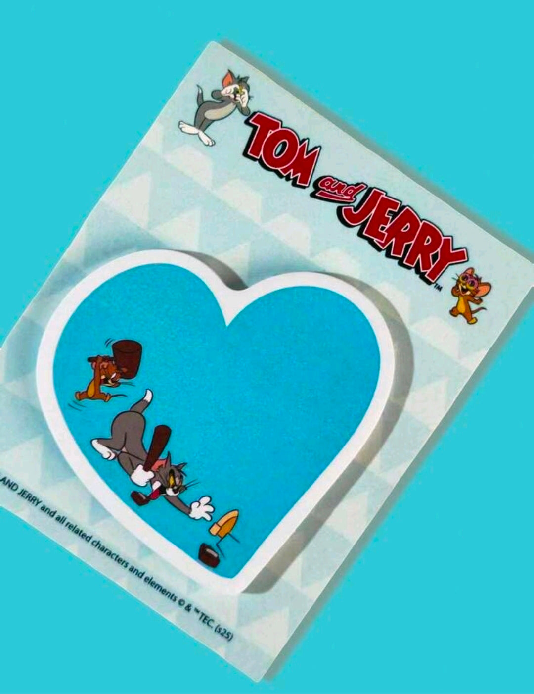 Close-up of blue heart-shaped Tom and Jerry sticky notes in clear packaging