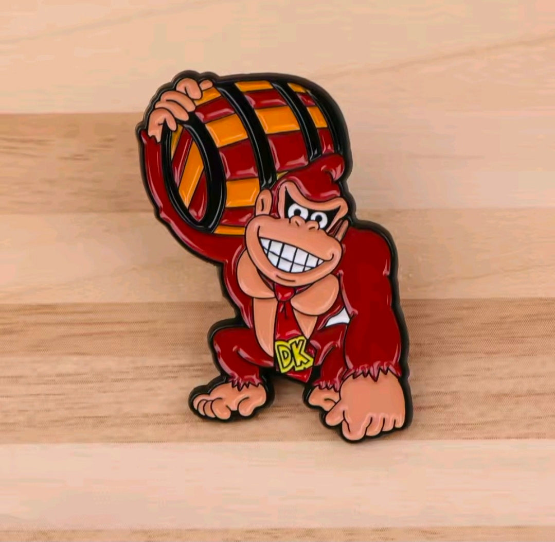 Donkey Kong with barrel enamel pin, red-haired character smiling and crouching