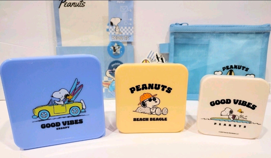 Set of three Peanuts mini storage tins: blue, yellow, and white with Snoopy art