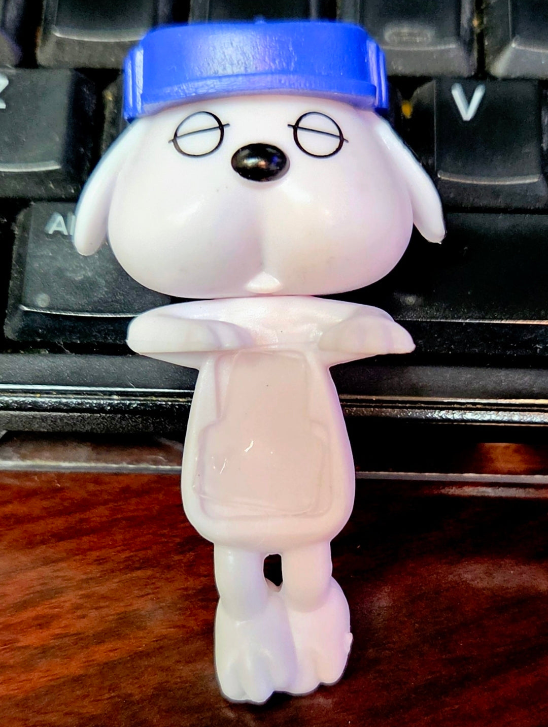 Blue-capped Olaf mini clip-on sleeping figure viewed from above, standing on keys