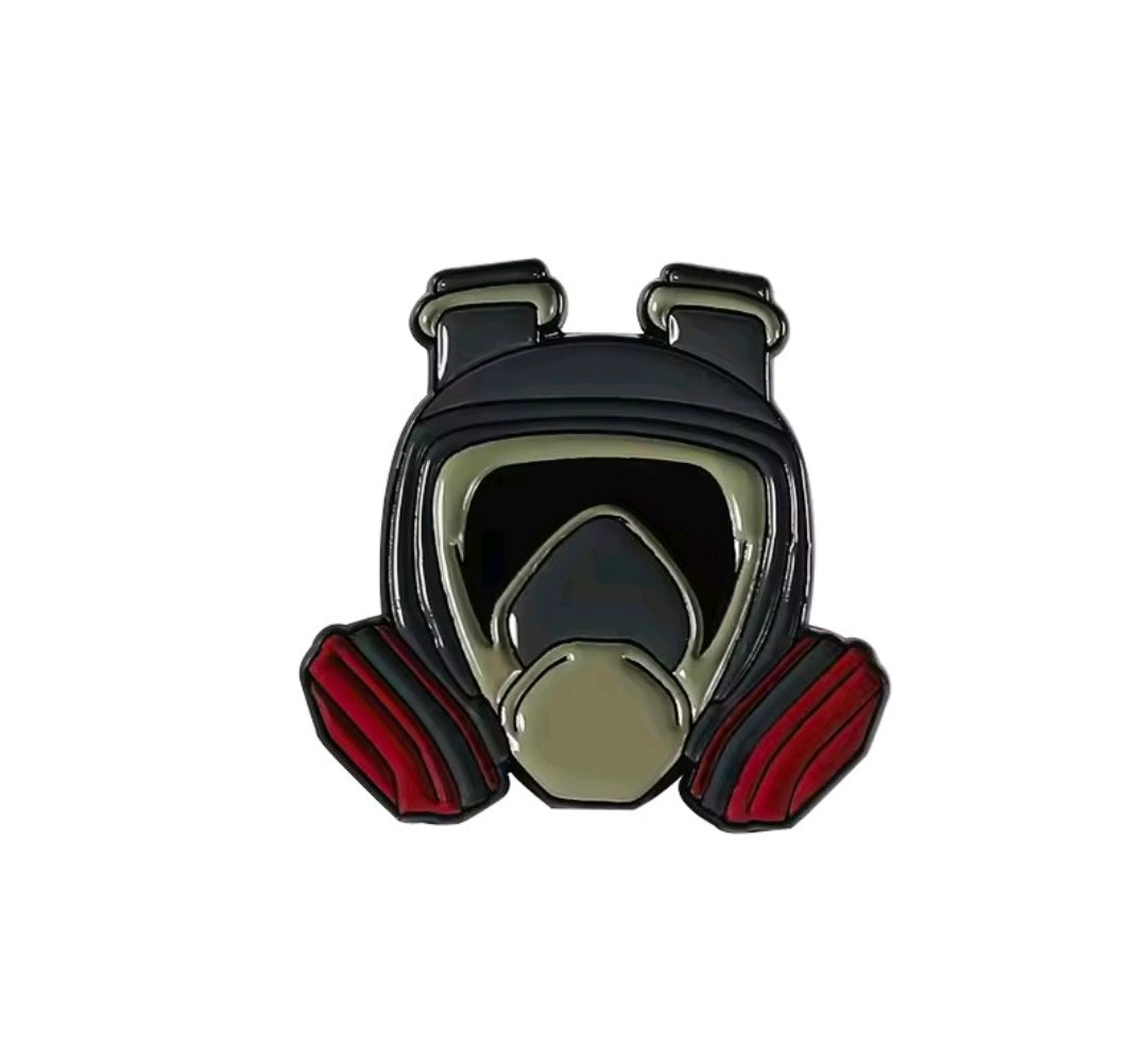 Gas mask enamel pin in olive and black with red striped gloves