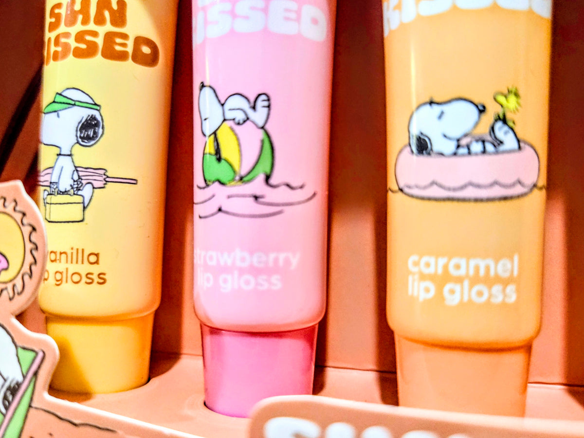 Sun Kissed lip gloss tubes: vanilla, strawberry, and caramel with character artwork