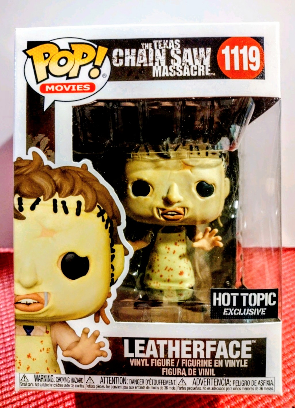 Vinyl figure box front with Leatherface character and Hot Topic exclusive badge