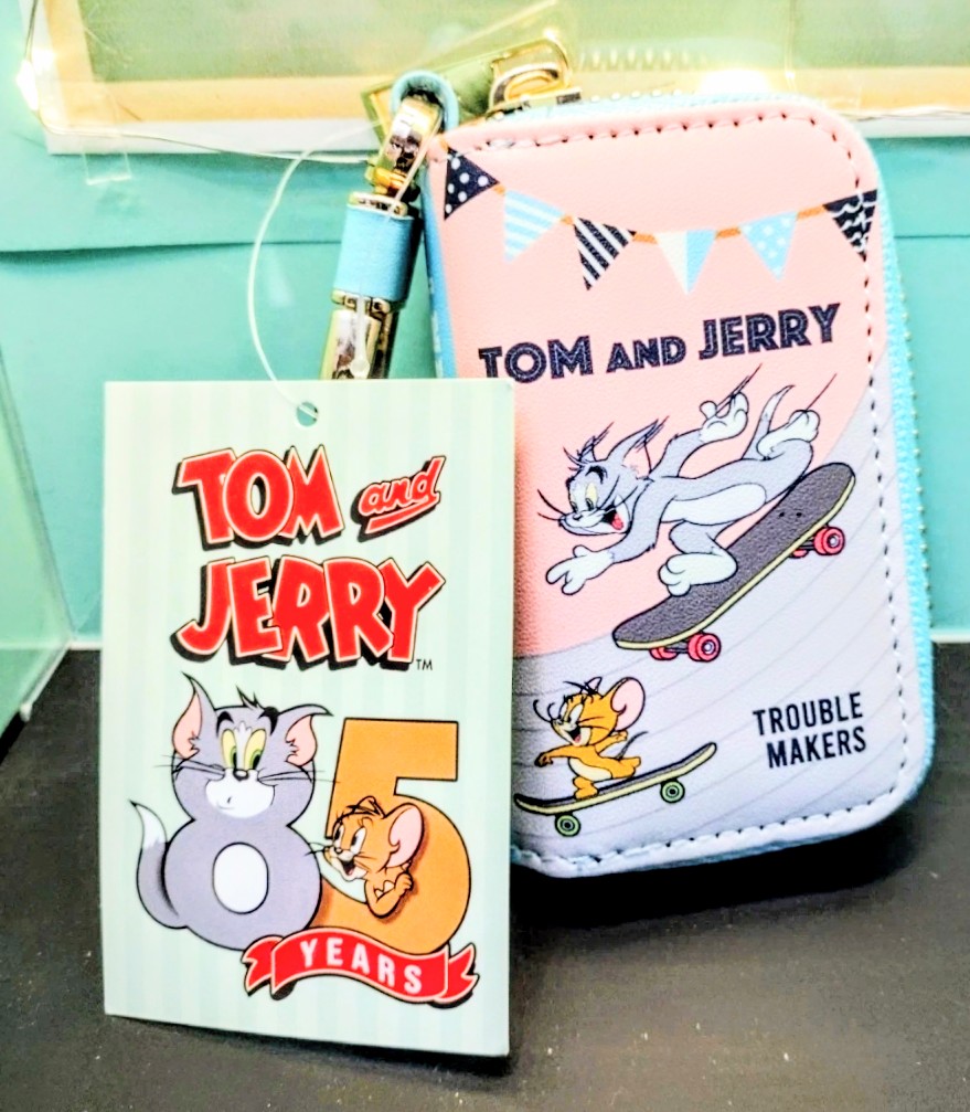 Pink Tom and Jerry smart key case on lanyard with skateboard character artwork