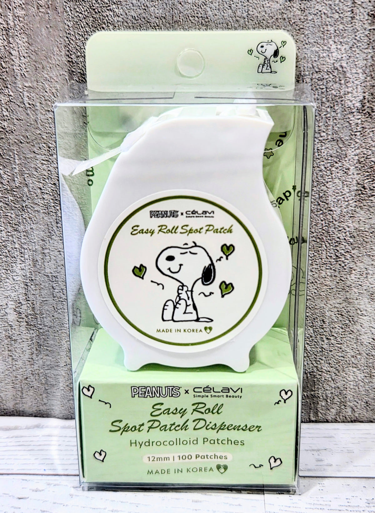 Peanuts x Celavi Easy Roll Spot Patch Dispenser with white base and clear front