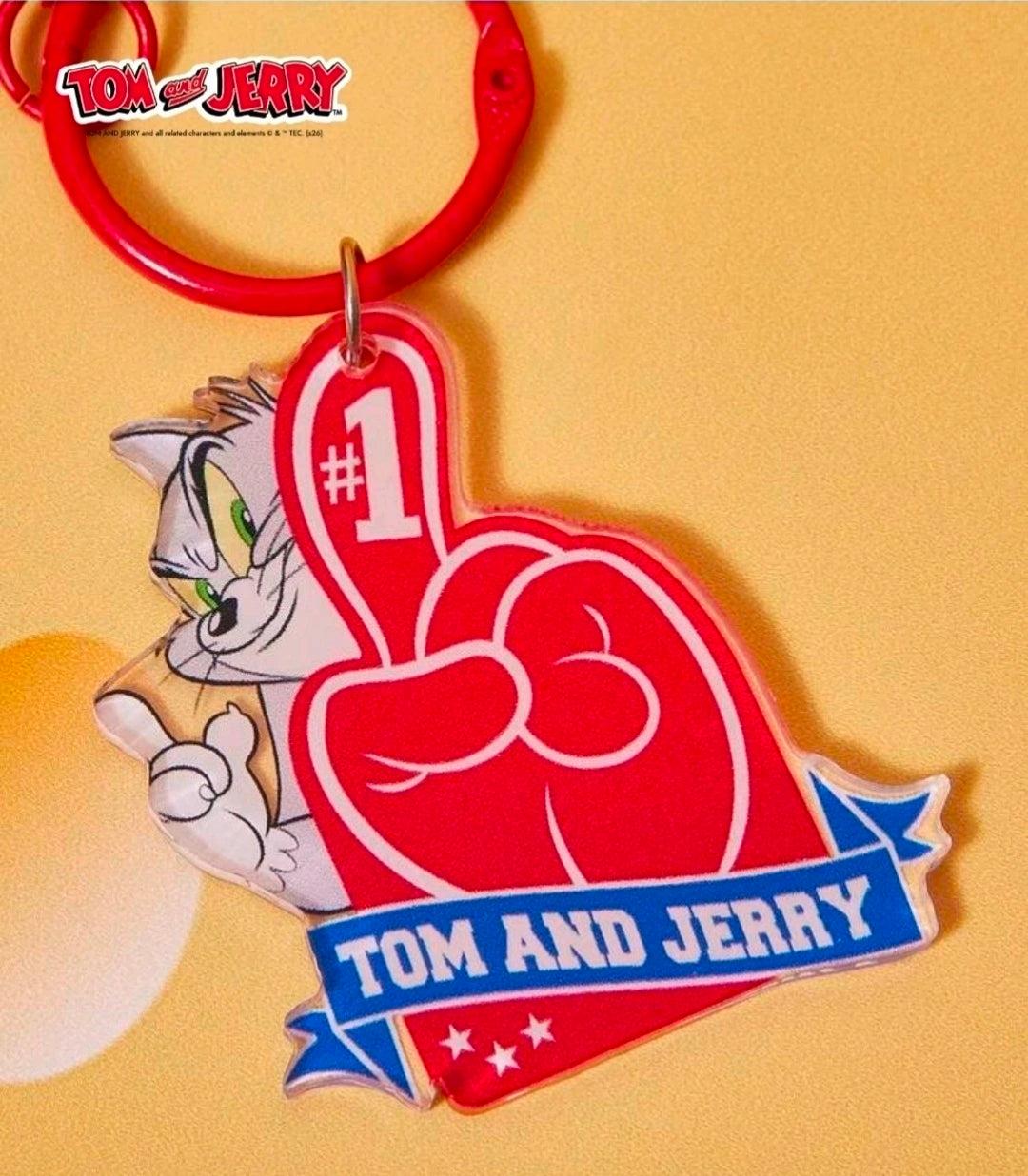 Red patriotic baseball keychain with #1 emblem and metal bell; Tom & Jerry character