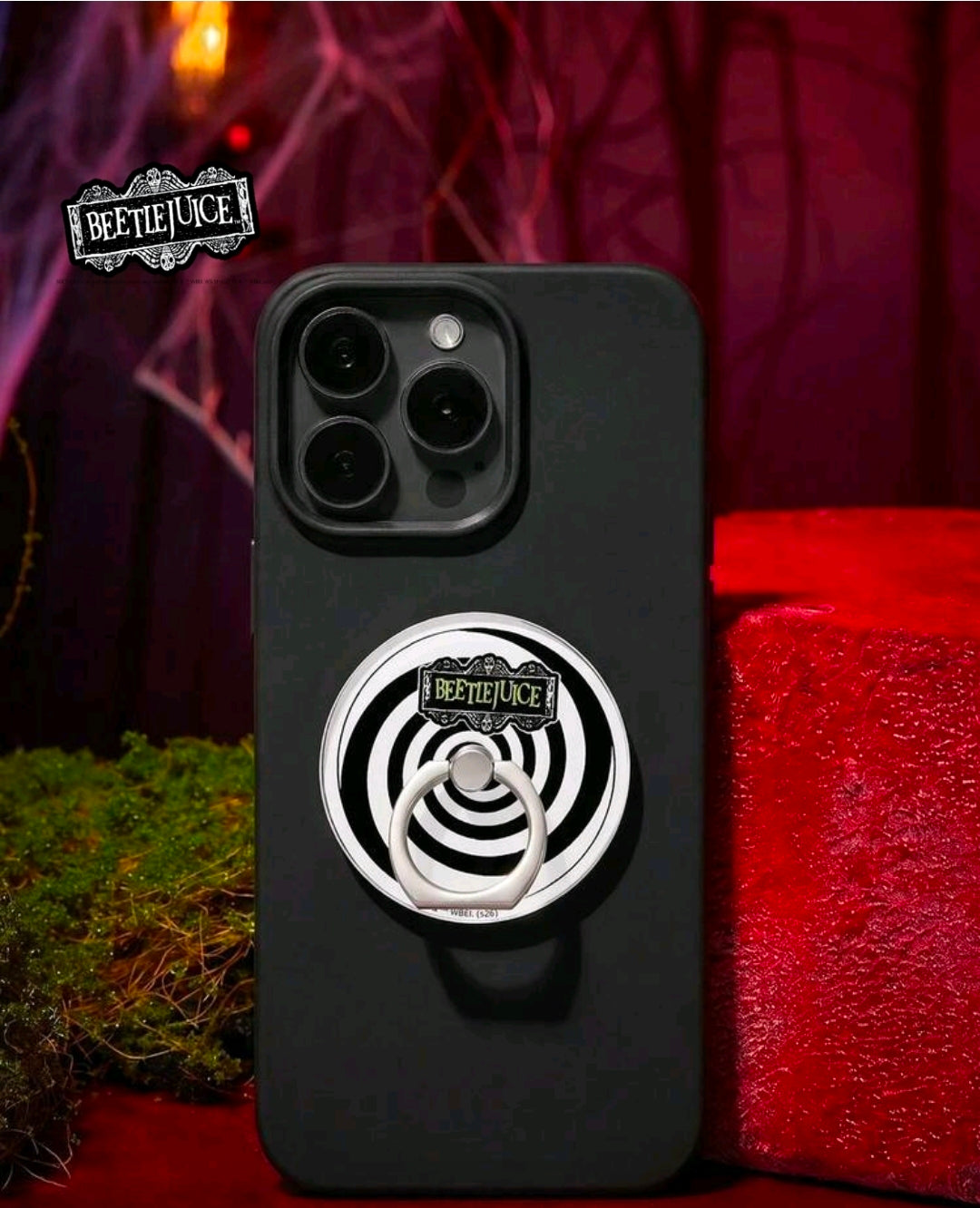 Matte black phone back with metal stick-on ring grip featuring white-and-black spiral