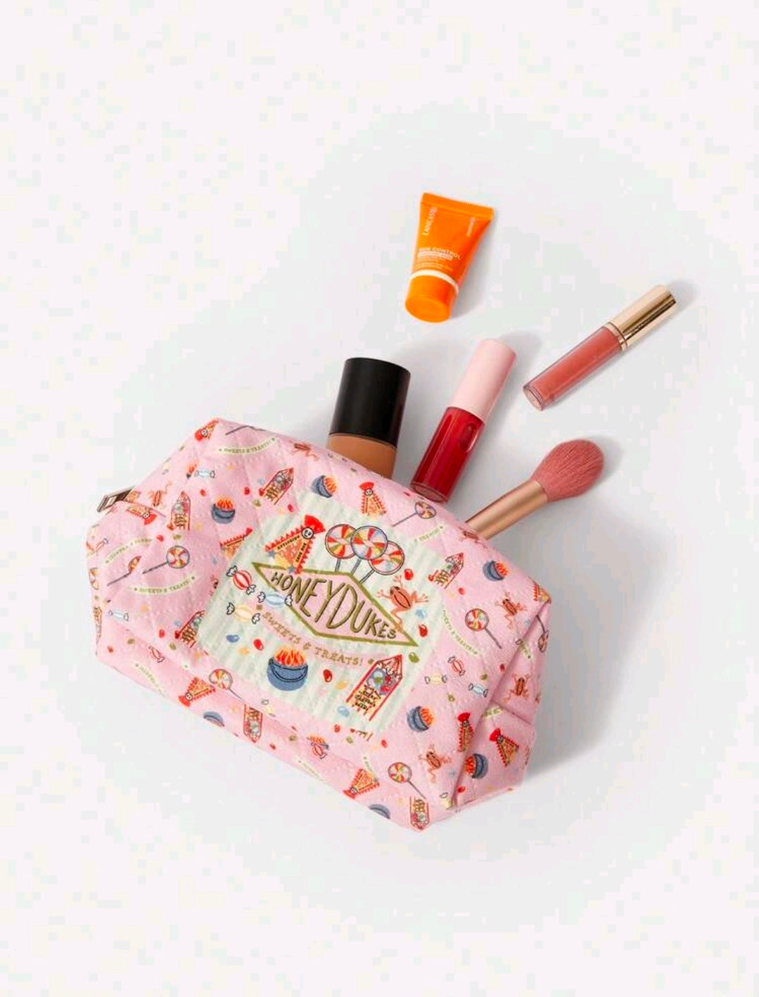 Pink Honeydukes patterned makeup pouch with zipper and front logo panel