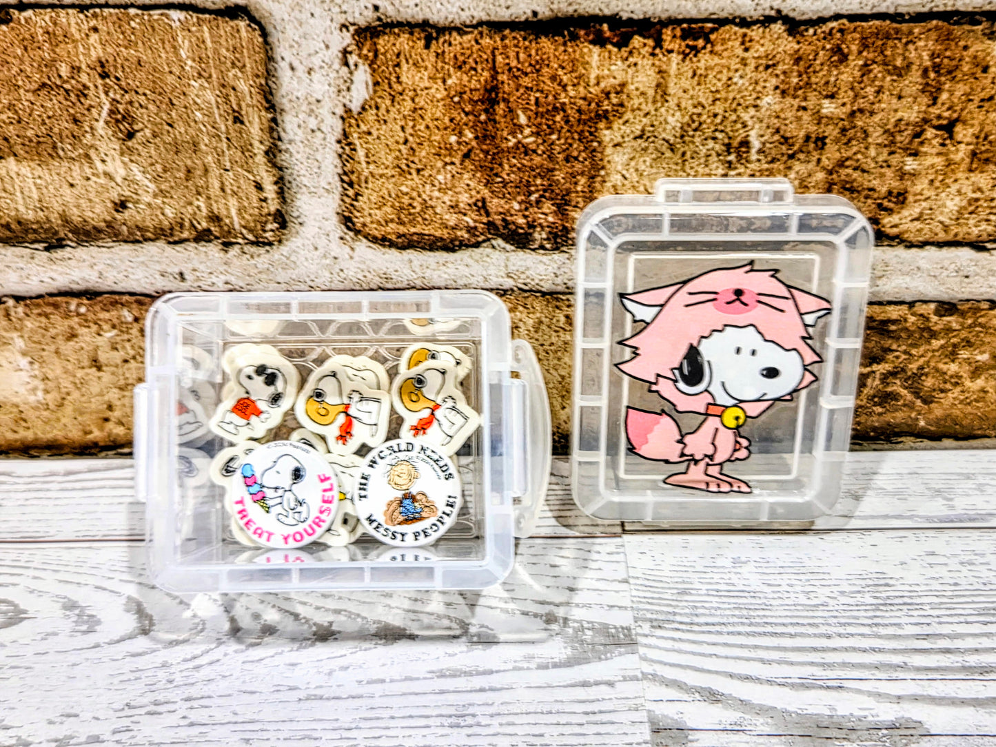 Two clear mini organizer boxes with Snoopy character graphics and visible erasers