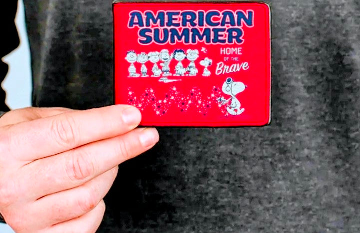 Red wallet card panel held in hand, showing American Summer design.