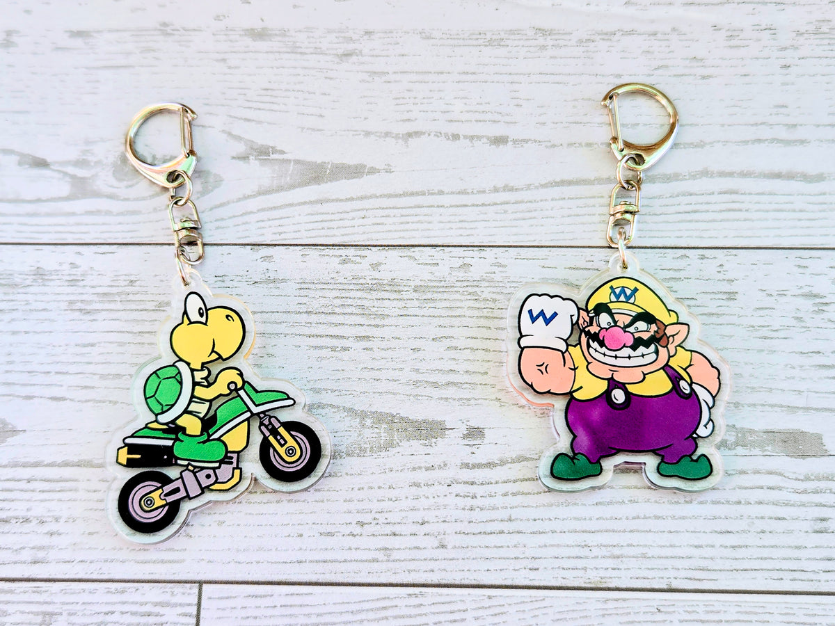 Acrylic keychain set with Koopa Troopa scooter charm and Wario purple charm