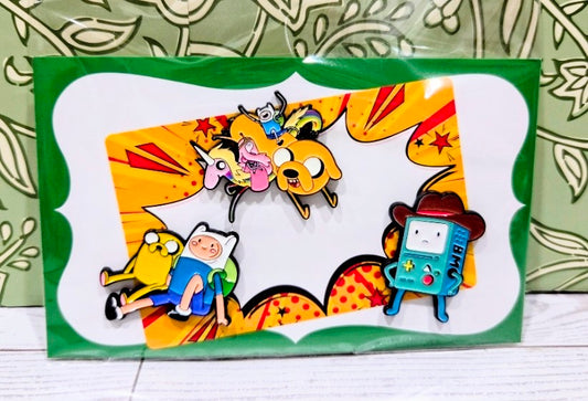 Enamel pin set in box window showing Jake, Finn, and BMO character pins