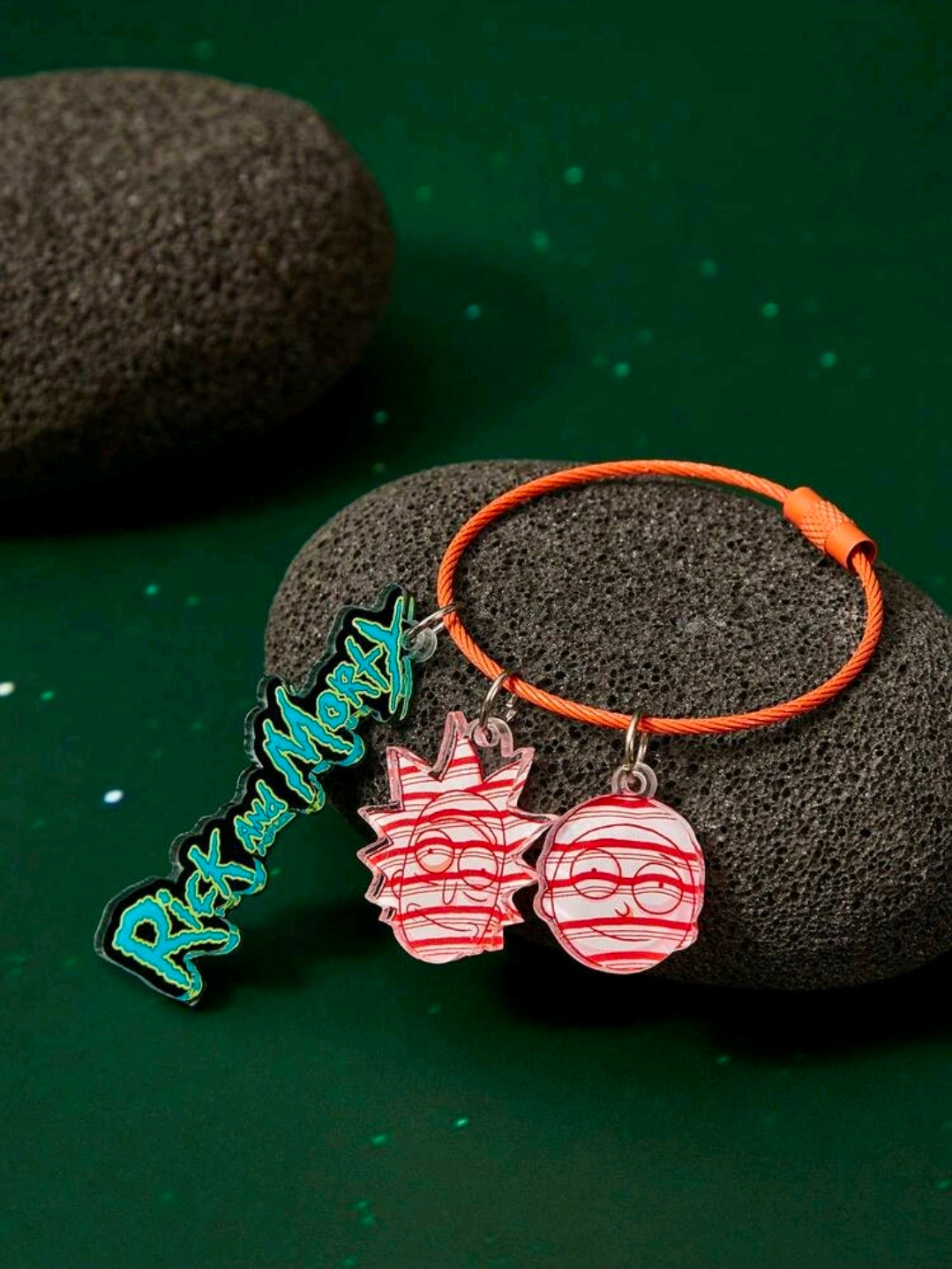 Braided orange wire keyring with blue name charm and two red acrylic character charms