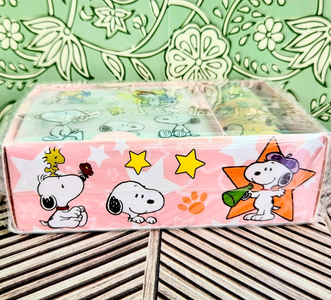 Pink sticker sheet with Snoopy, Woodstock, paw prints, and yellow star accents