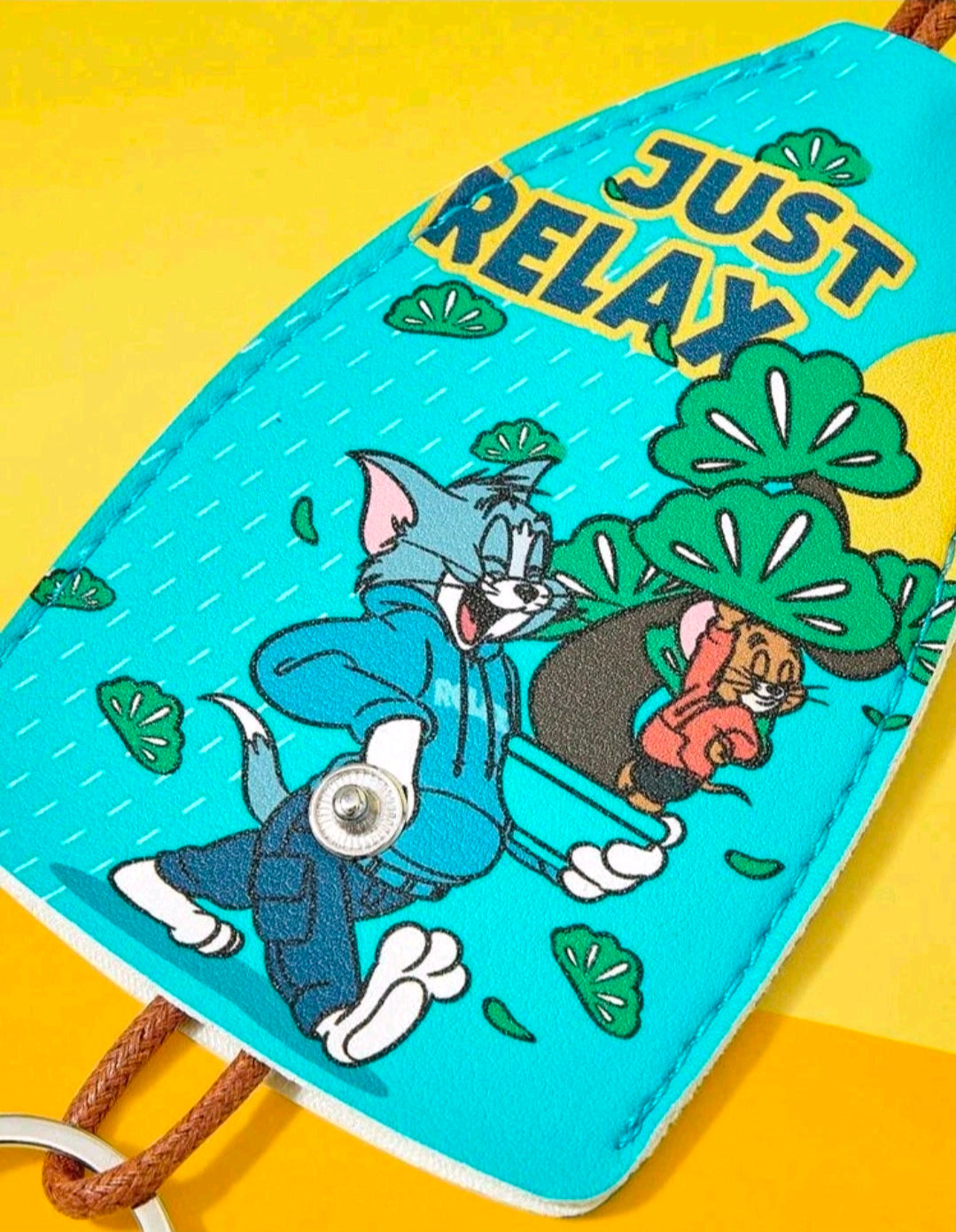 Teal pouch with Just Relax text, cartoon cat and mouse, snap button