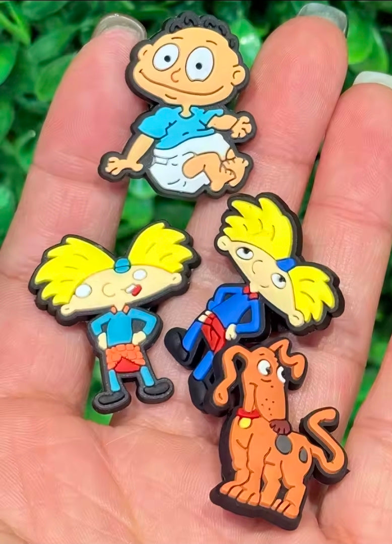13-piece PVC cartoon shoe bag charm set with multiple character figures in hand