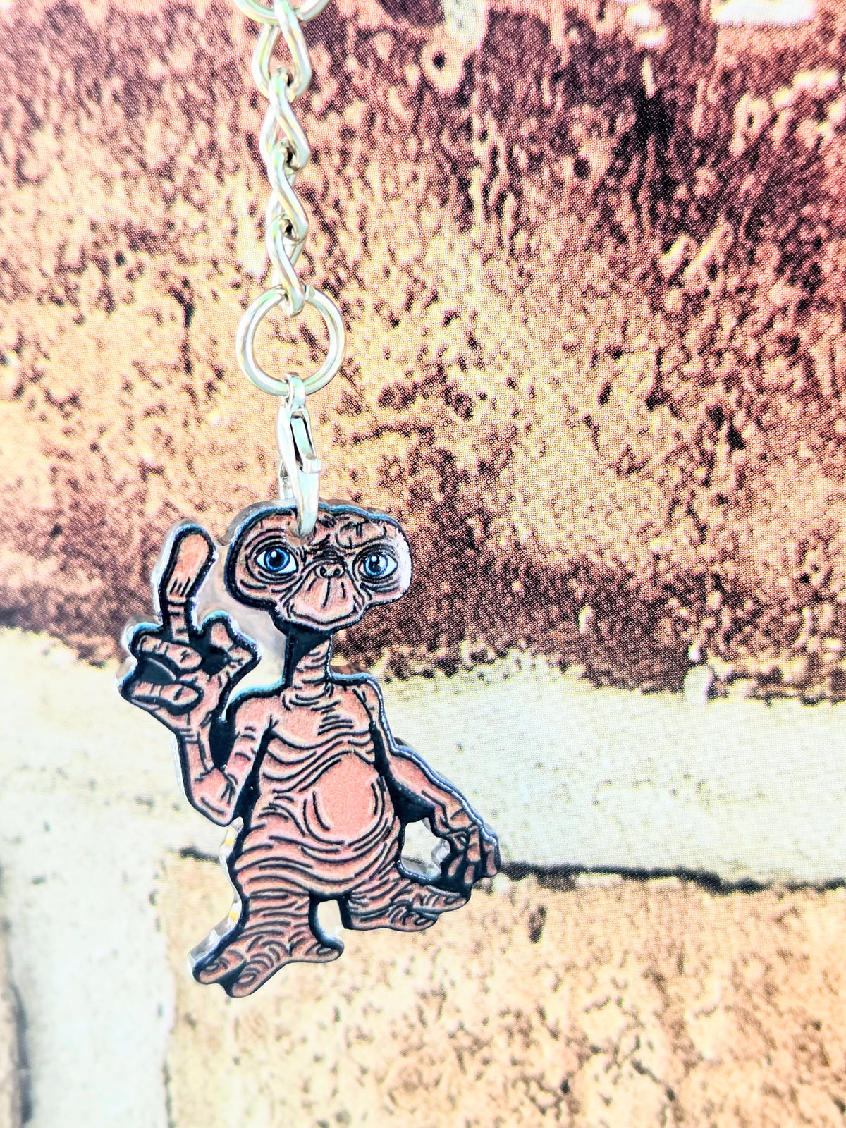 Acrylic E.T. die-cut keychain on silver chain with gold ring, alien waving a hand
