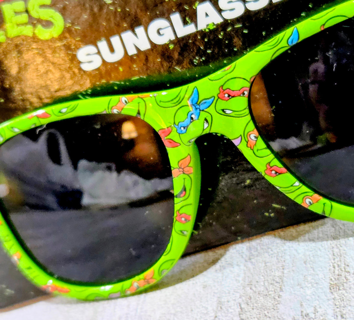 Green Teenage Mutant Ninja Turtles sunglasses with black lenses