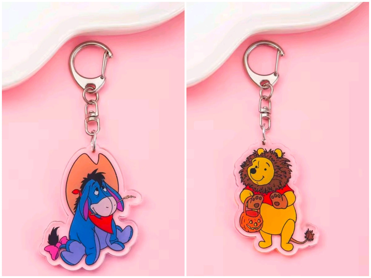 Acrylic Halloween keychain with carabiner; blue character holding a heart and bow charm.