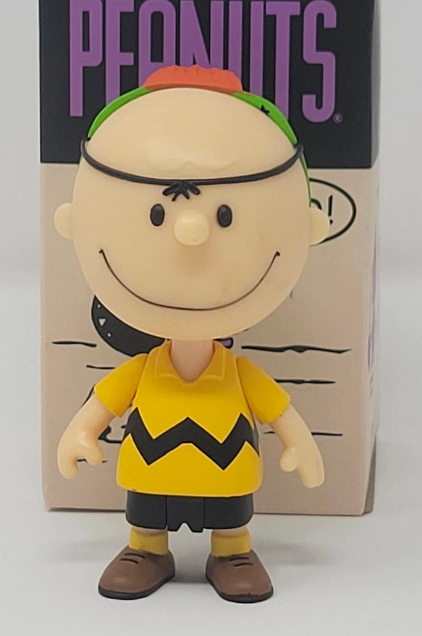Halloween vinyl blind box figure wearing a yellow zigzag shirt and a green headband