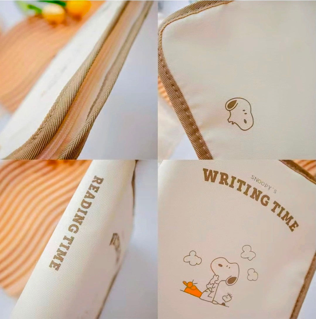 Close-up of beige portfolio cover with brown piping and “Writing Time” Snoopy print