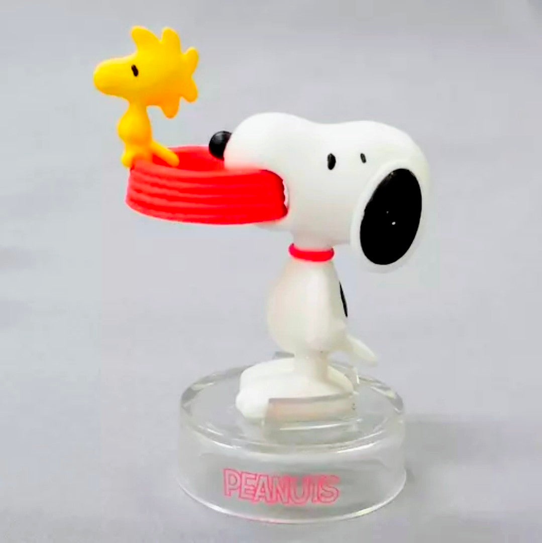 Snoopy figure with red-striped staff and yellow star, clear PEANUTS base
