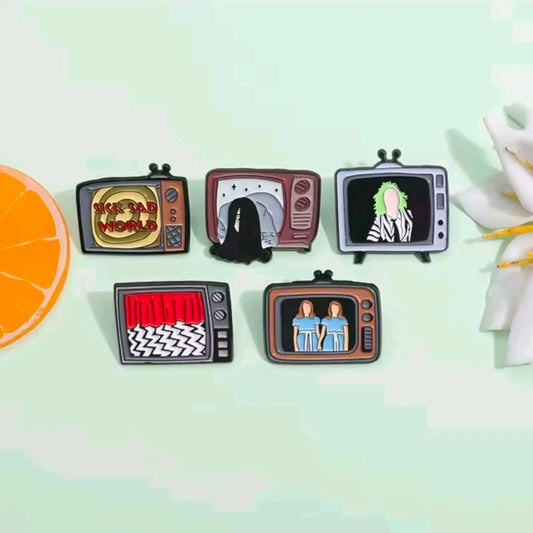 Five-piece enamel pin set with five TV screen character pins, arranged in a row.