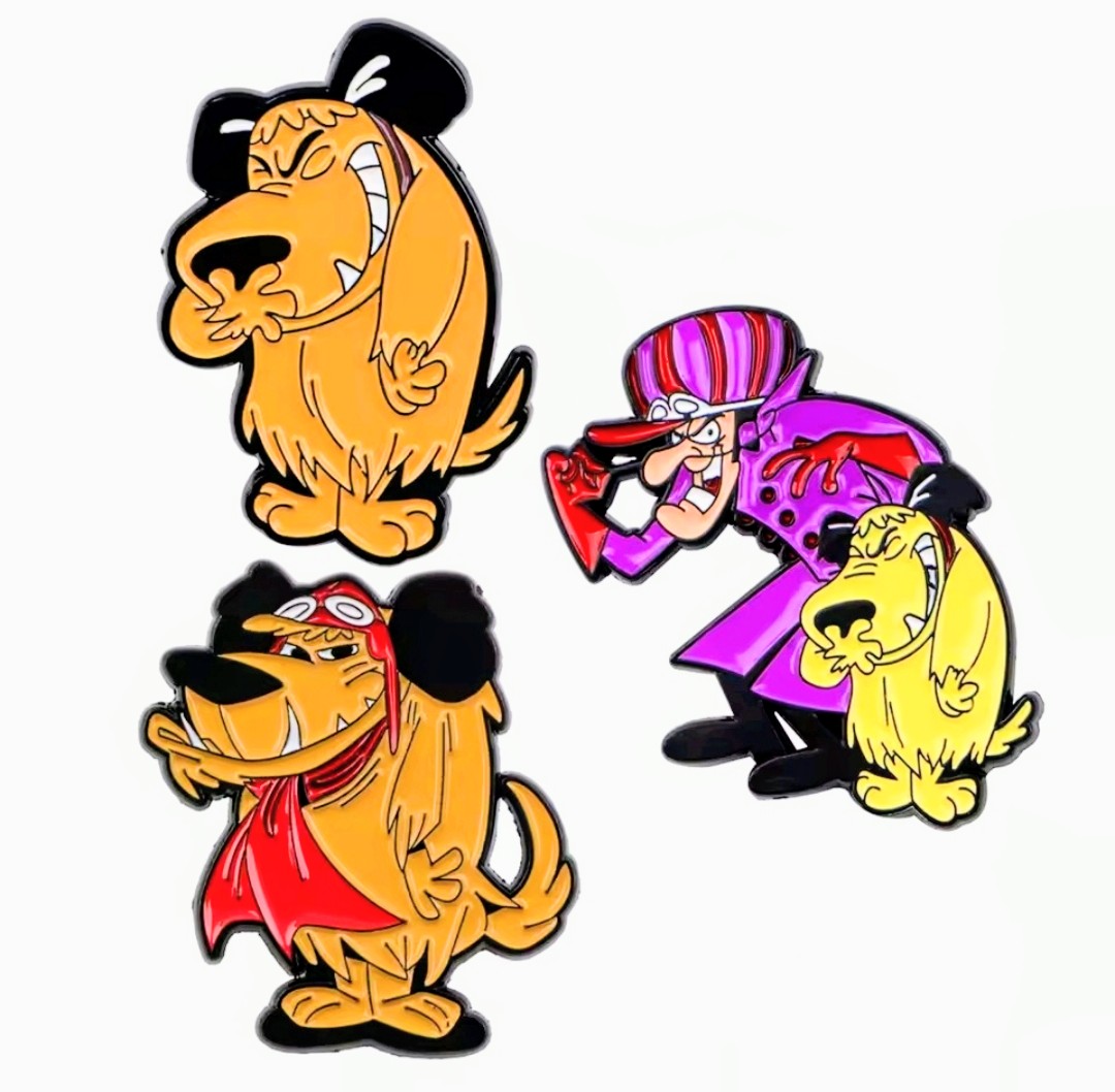 Three cartoon dog enamel pins with orange, red outfit, and purple action character