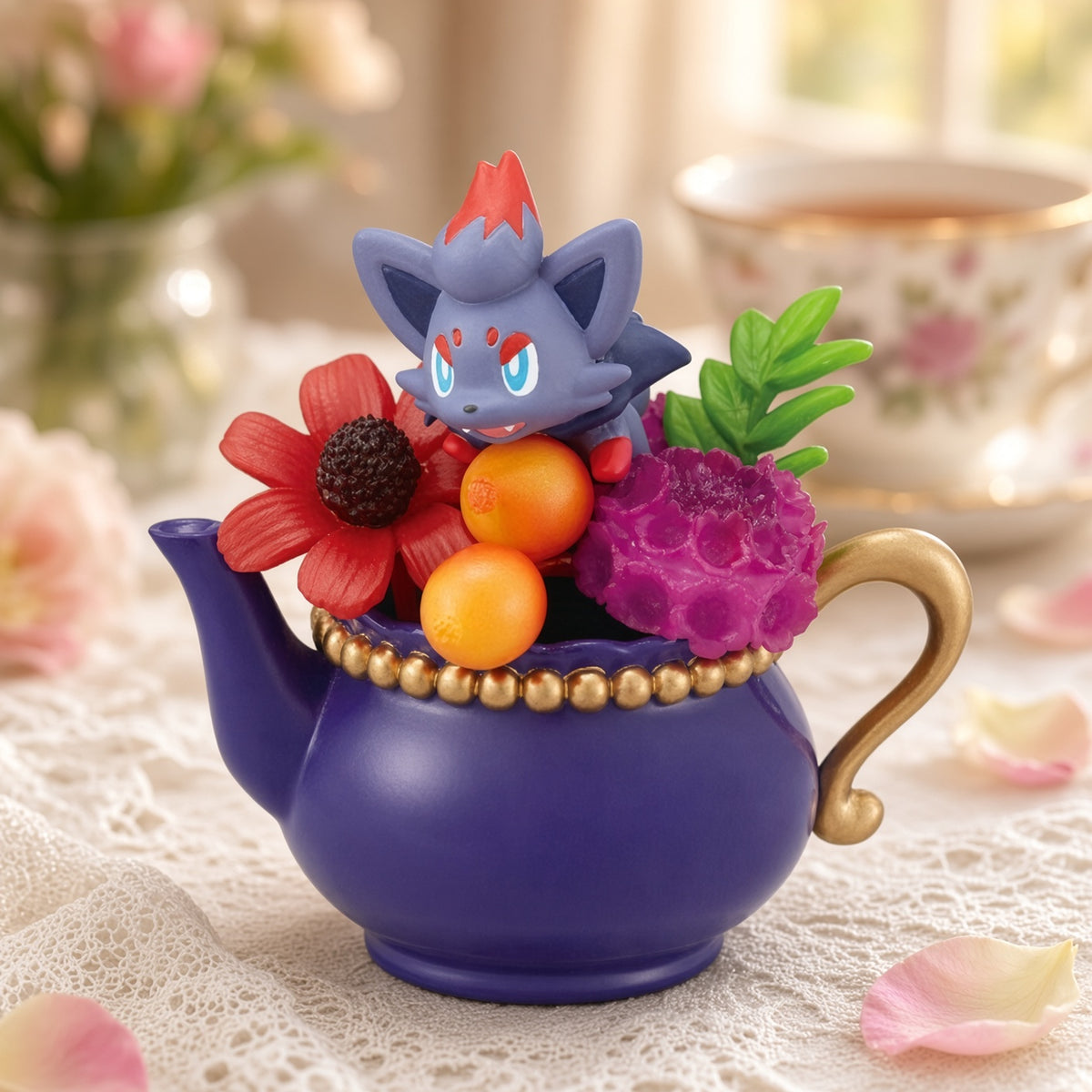 Purple teapot mini figure with grey cat, red flower, orange fruit beads, and pink blooms